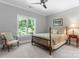 Bright bedroom featuring a classic wood bed frame, neutral walls, and a large window at 12835 Ninebark Trl, Charlotte, NC 28278
