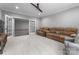 Spacious bonus room features neutral walls, carpet flooring, a brown sofa and french doors at 12835 Ninebark Trl, Charlotte, NC 28278