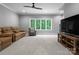 Large bonus room features neutral walls, carpet flooring, a brown sofa and a large window at 12835 Ninebark Trl, Charlotte, NC 28278