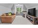 Bonus room with neutral walls, carpet, a comfortable sofa, and a large window for natural light at 12835 Ninebark Trl, Charlotte, NC 28278