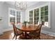 Bright breakfast nook featuring a wood table set and large windows with views of the lush outdoors at 12835 Ninebark Trl, Charlotte, NC 28278