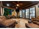 Cozy covered porch features a ceiling fan, grill, and comfortable outdoor seating at 12835 Ninebark Trl, Charlotte, NC 28278