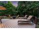 Outdoor deck featuring lounge chairs and seating surrounding a fire pit at 12835 Ninebark Trl, Charlotte, NC 28278