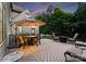 Outdoor deck featuring a round table, chairs, and seating surrounding a fire pit at 12835 Ninebark Trl, Charlotte, NC 28278