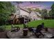 Exterior view of house featuring a backyard stone firepit, chairs, and elevated decks at 12835 Ninebark Trl, Charlotte, NC 28278