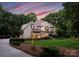 Beautiful exterior view of the home showing the well-maintained lawn and lush surrounding trees at 12835 Ninebark Trl, Charlotte, NC 28278
