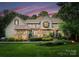Charming stone and wood home featuring mature landscaping and beautiful architectural details at 12835 Ninebark Trl, Charlotte, NC 28278