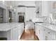 Bright kitchen with white cabinets, hardwood floors, stainless steel appliances, and ample counter space at 12835 Ninebark Trl, Charlotte, NC 28278