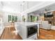 Open kitchen design with a large island, and a view into the living room with a stone fireplace at 12835 Ninebark Trl, Charlotte, NC 28278
