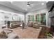Open living room with hardwood floors, cozy seating, and views of the adjacent kitchen and outdoor space at 12835 Ninebark Trl, Charlotte, NC 28278