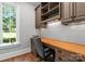 Dedicated office space featuring custom built-ins, a wooden desk, and a window for natural light at 12835 Ninebark Trl, Charlotte, NC 28278