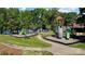 Playground features climbing wall, slides, and picnic tables for , with lush trees and lake views at 12835 Ninebark Trl, Charlotte, NC 28278