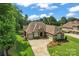 Expansive aerial view of the brick home, driveway, three-car garage and professionally landscaped yard at 1400 Delaney Dr, Matthews, NC 28104