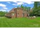 Spacious backyard with brick house and outdoor seating area at 1400 Delaney Dr, Matthews, NC 28104