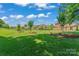 Expansive, well-maintained lawn with mature trees offering shade in a neighborhood setting at 1400 Delaney Dr, Matthews, NC 28104