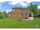 Brick house with lush green lawn and outdoor seating at 1400 Delaney Dr, Matthews, NC 28104