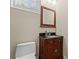 Cozy powder room with wooden vanity and dark countertop at 1400 Delaney Dr, Matthews, NC 28104