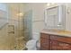 Bathroom with walk-in shower, granite vanity, and neutral tile at 1400 Delaney Dr, Matthews, NC 28104
