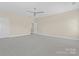 Spacious bedroom featuring neutral walls, carpeted floors, and a ceiling fan at 1400 Delaney Dr, Matthews, NC 28104