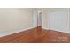 Bright bedroom features wood flooring and two closet doors at 1400 Delaney Dr, Matthews, NC 28104