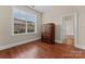 Bedroom featuring hardwood floors, neutral walls, and natural light at 1400 Delaney Dr, Matthews, NC 28104