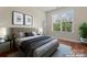 Cozy bedroom with stylish decor, artwork, and a comfortable bed near a window at 1400 Delaney Dr, Matthews, NC 28104