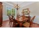 Formal dining room with wood floors, large windows, elegant chandelier, and classic decor at 1400 Delaney Dr, Matthews, NC 28104