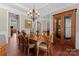 Formal dining room featuring hardwood floors, elegant chandelier and custom wood cabinet for elegant dining at 1400 Delaney Dr, Matthews, NC 28104
