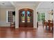 Elegant entryway with a double door entrance, hardwood floors, and views of the formal dining room at 1400 Delaney Dr, Matthews, NC 28104