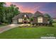 Beautiful brick home boasts a manicured lawn and lush landscaping in a desirable community at 1400 Delaney Dr, Matthews, NC 28104
