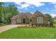 Charming brick home features a well-manicured lawn and mature landscaping in a desirable community at 1400 Delaney Dr, Matthews, NC 28104