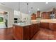 Large island kitchen with granite countertops, pendant lighting, open floor plan to living area at 1400 Delaney Dr, Matthews, NC 28104