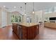 Open-concept living space featuring a kitchen island with granite counters, stainless steel dishwasher at 1400 Delaney Dr, Matthews, NC 28104