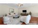 Bright living room featuring hardwood floors, modern furnishings and recessed lighting at 1400 Delaney Dr, Matthews, NC 28104
