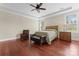 Bright bedroom featuring wood floors, crown molding, and large windows, with ample natural light at 1400 Delaney Dr, Matthews, NC 28104