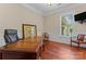 Home office featuring hardwood floors, classic wainscoting, neutral paint, and natural light at 1400 Delaney Dr, Matthews, NC 28104