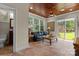 Inviting sunroom with wood ceiling, tile floor, and ample natural light from large windows and glass sliding doors at 1400 Delaney Dr, Matthews, NC 28104