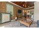 Sunroom featuring brick walls, wood ceiling, tiled floor, and glass sliding doors for natural light at 1400 Delaney Dr, Matthews, NC 28104