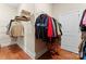 Walk-in closet with wooden floors and white walls, with plenty of hanging storage space and shelving at 1400 Delaney Dr, Matthews, NC 28104
