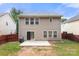 Two-story home featuring a patio, lawn, neutral vinyl siding, and fenced yard at 14010 Pinyon Pine Ln, Charlotte, NC 28215