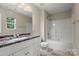 Well-lit bathroom featuring a vanity with granite top, tile floor, and shower-tub combo at 14010 Pinyon Pine Ln, Charlotte, NC 28215