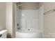 Bathroom featuring a shower-tub combo with white tile at 14010 Pinyon Pine Ln, Charlotte, NC 28215