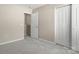 Neutral carpeted bedroom features base trim, closet with standard doors, and attached area at 14010 Pinyon Pine Ln, Charlotte, NC 28215