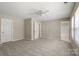 Spacious bedroom featuring neutral carpet and multiple doorways and natural light at 14010 Pinyon Pine Ln, Charlotte, NC 28215