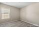 Cozy bedroom featuring neutral walls, carpet, base trim, and natural light from a large window at 14010 Pinyon Pine Ln, Charlotte, NC 28215