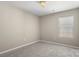 Carpeted bedroom with a window offering natural light, providing a cozy and private retreat at 14010 Pinyon Pine Ln, Charlotte, NC 28215