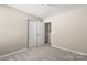 Neutral bedroom featuring carpet, base trim, and closet with a standard-sized door at 14010 Pinyon Pine Ln, Charlotte, NC 28215