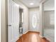 Bright entryway featuring hardwood floors, white trim, and half bathroom at 14010 Pinyon Pine Ln, Charlotte, NC 28215