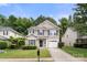 Inviting two-story home with green shutters and lush green landscaping at 14010 Pinyon Pine Ln, Charlotte, NC 28215