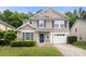 Charming two-story home with blue shutters, attached garage, manicured landscaping, and an inviting front entrance at 14010 Pinyon Pine Ln, Charlotte, NC 28215